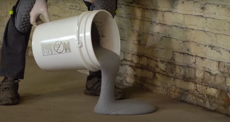 Pouring a unit of Cooler Crete cold storage floor repair epoxy