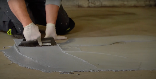 Acid Crete floor epoxy being applied to a concrete floor