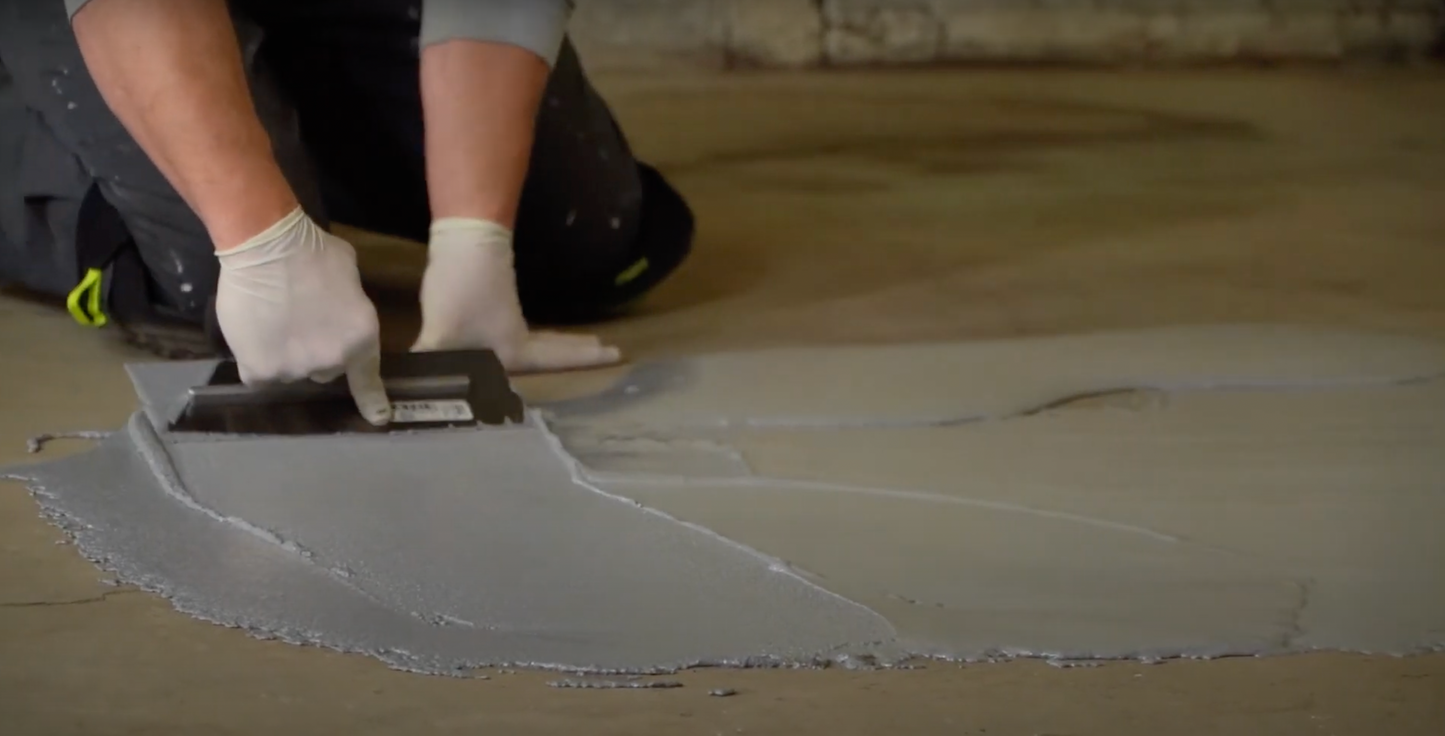 applying pox a crete epoxy floor repair to a concrete floor