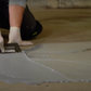 applying cooler crete floor epoxy with a trowel in cold storage